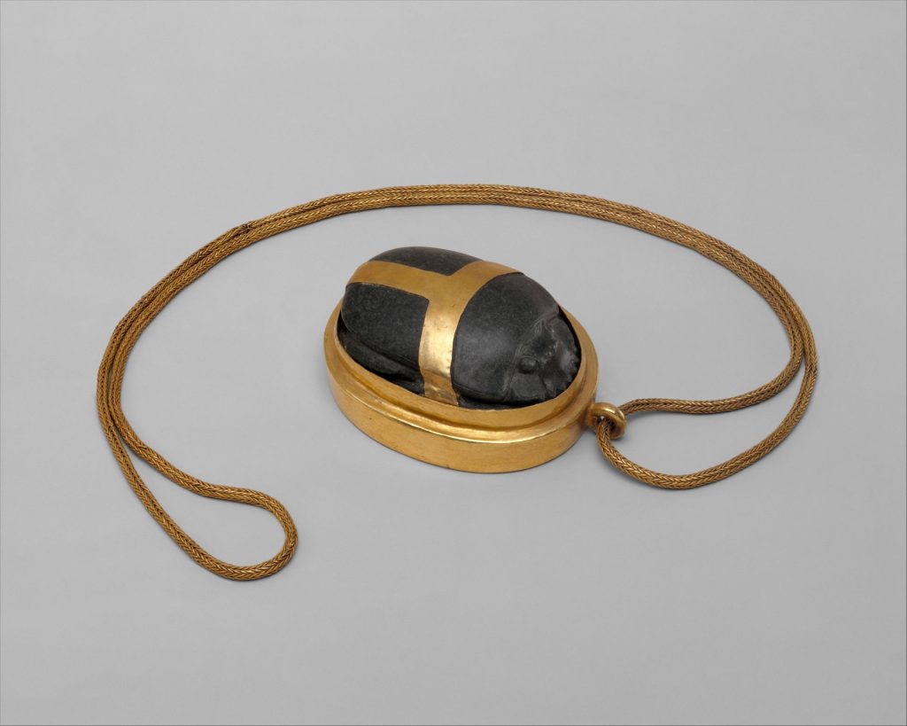 Heart Scarab of Hatnefer, an ancient Egyptian funerary amulet made of serpentinite and gold with a braided gold chain.